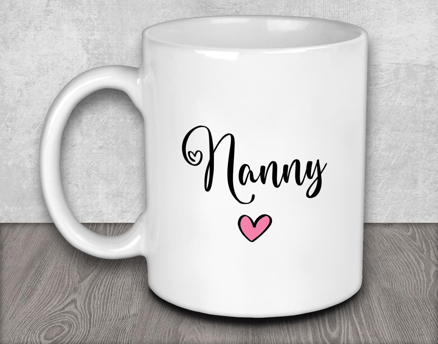 a white coffee mug with a pink heart on it