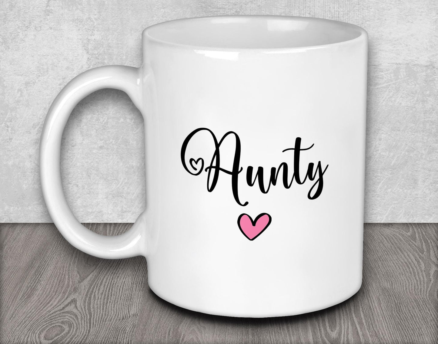 a white coffee mug with a pink heart on it