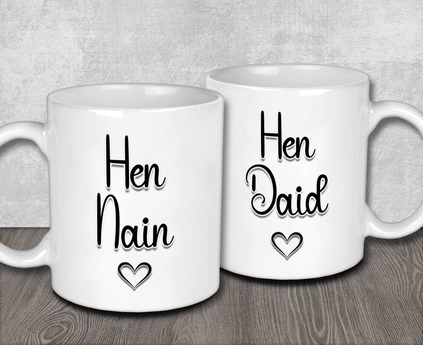 two white coffee mugs with the words hen and dad printed on them