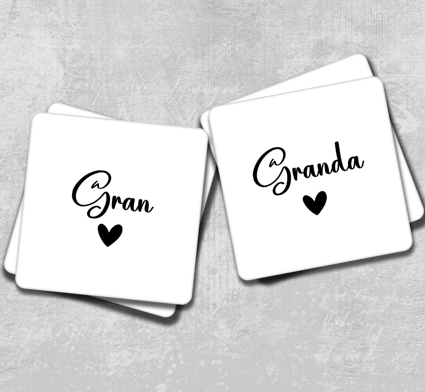 two square coasters with the words grand and grand written on them