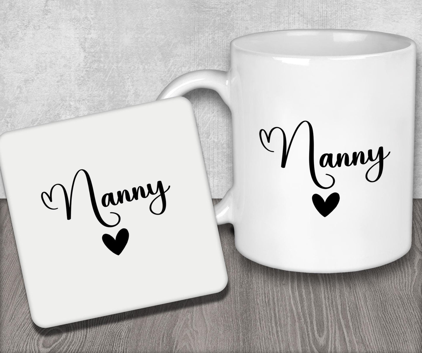 a couple of white coffee mugs sitting on top of a wooden table
