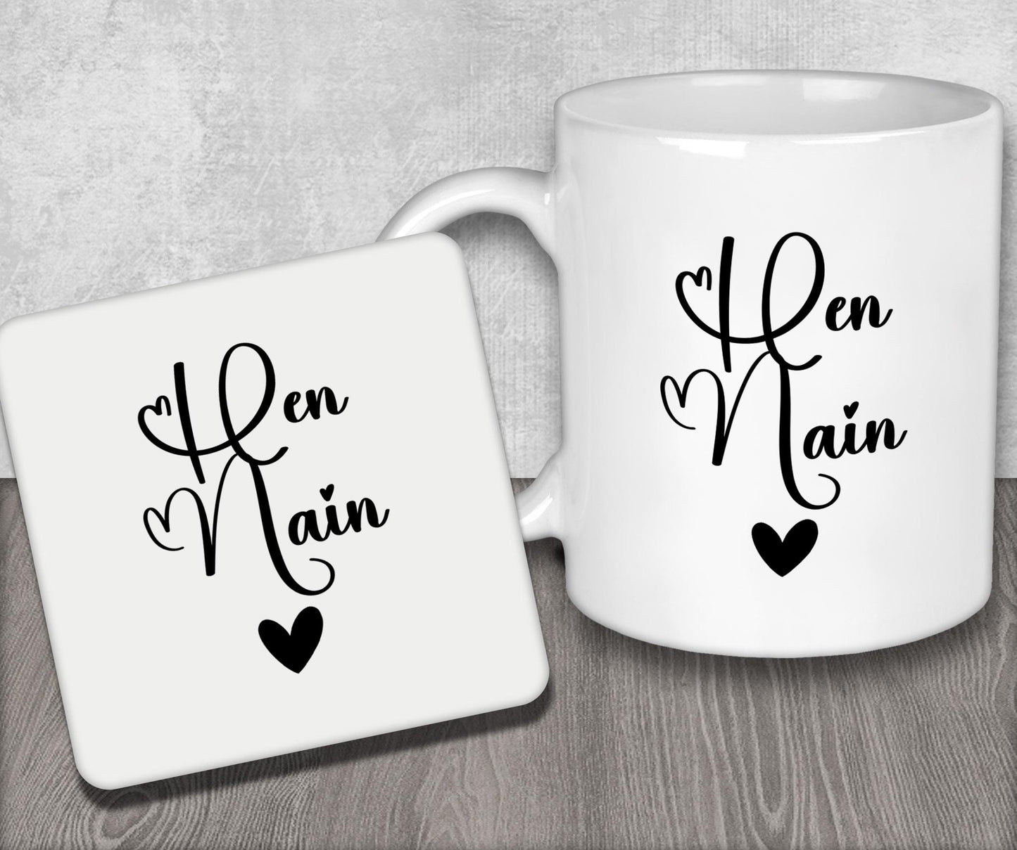 a couple of white coffee mugs sitting on top of a wooden table