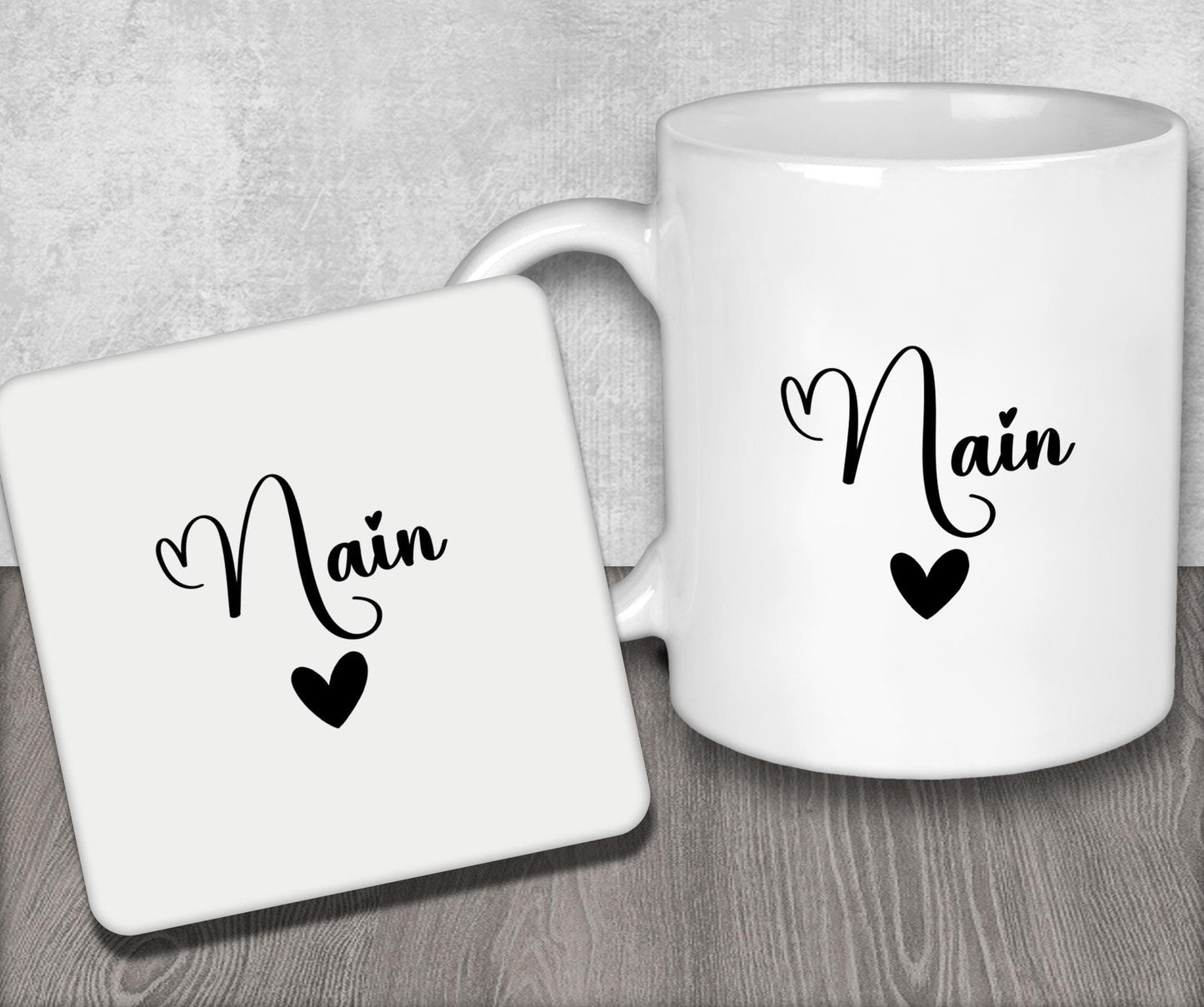 a couple of white coffee mugs sitting on top of a wooden table