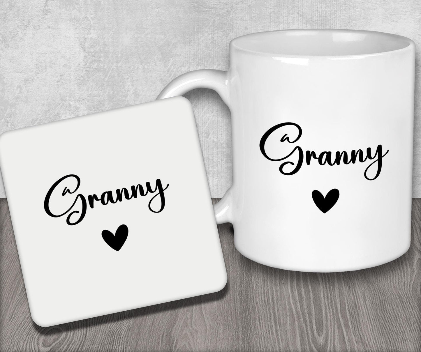 a couple of white coffee mugs sitting on top of a wooden table