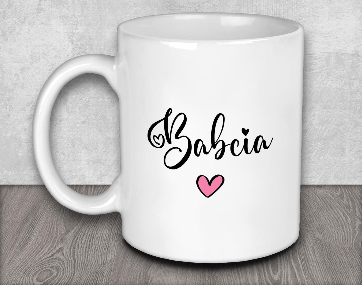 a white coffee mug with a pink heart on it