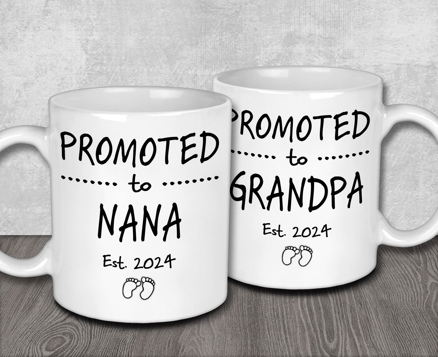 two white coffee mugs sitting on top of a wooden table