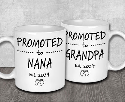 two white coffee mugs sitting on top of a wooden table