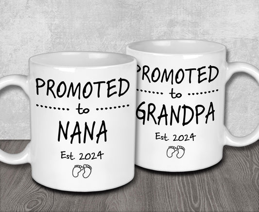 two white coffee mugs sitting on top of a wooden table