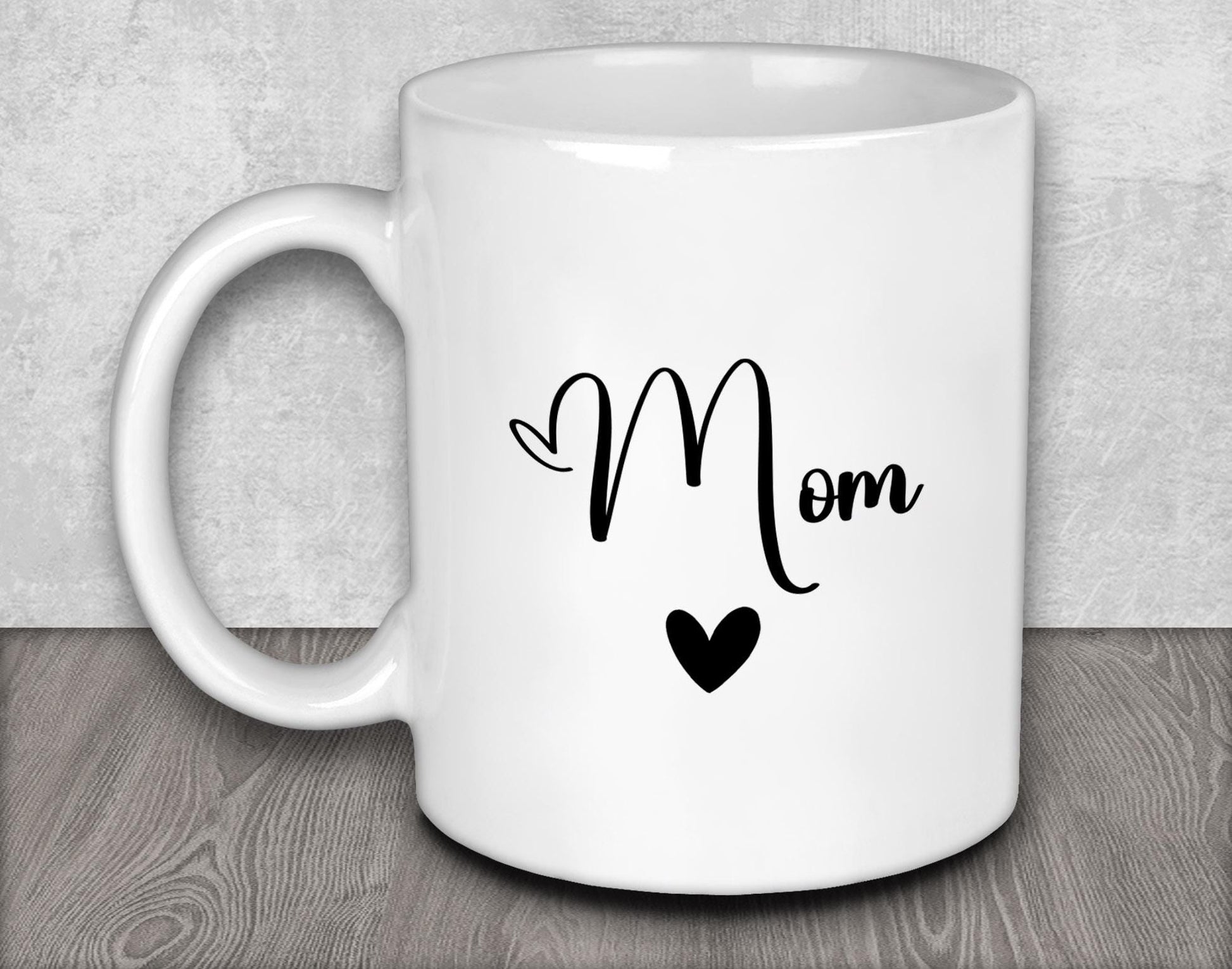 a white coffee mug with the word mom written on it