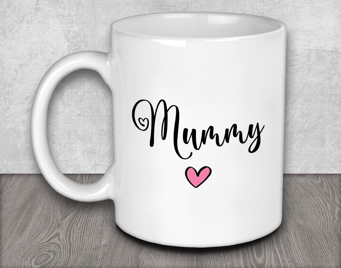 a white coffee mug with a pink heart on it