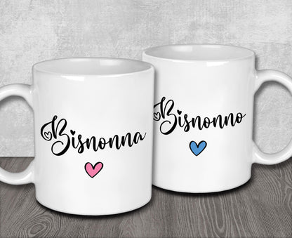 two white coffee mugs sitting on top of a wooden table