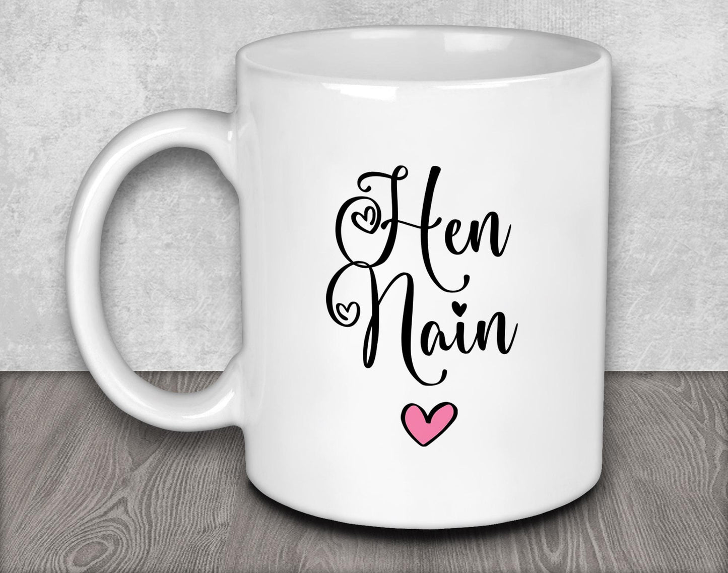 a white coffee mug with a pink heart on it