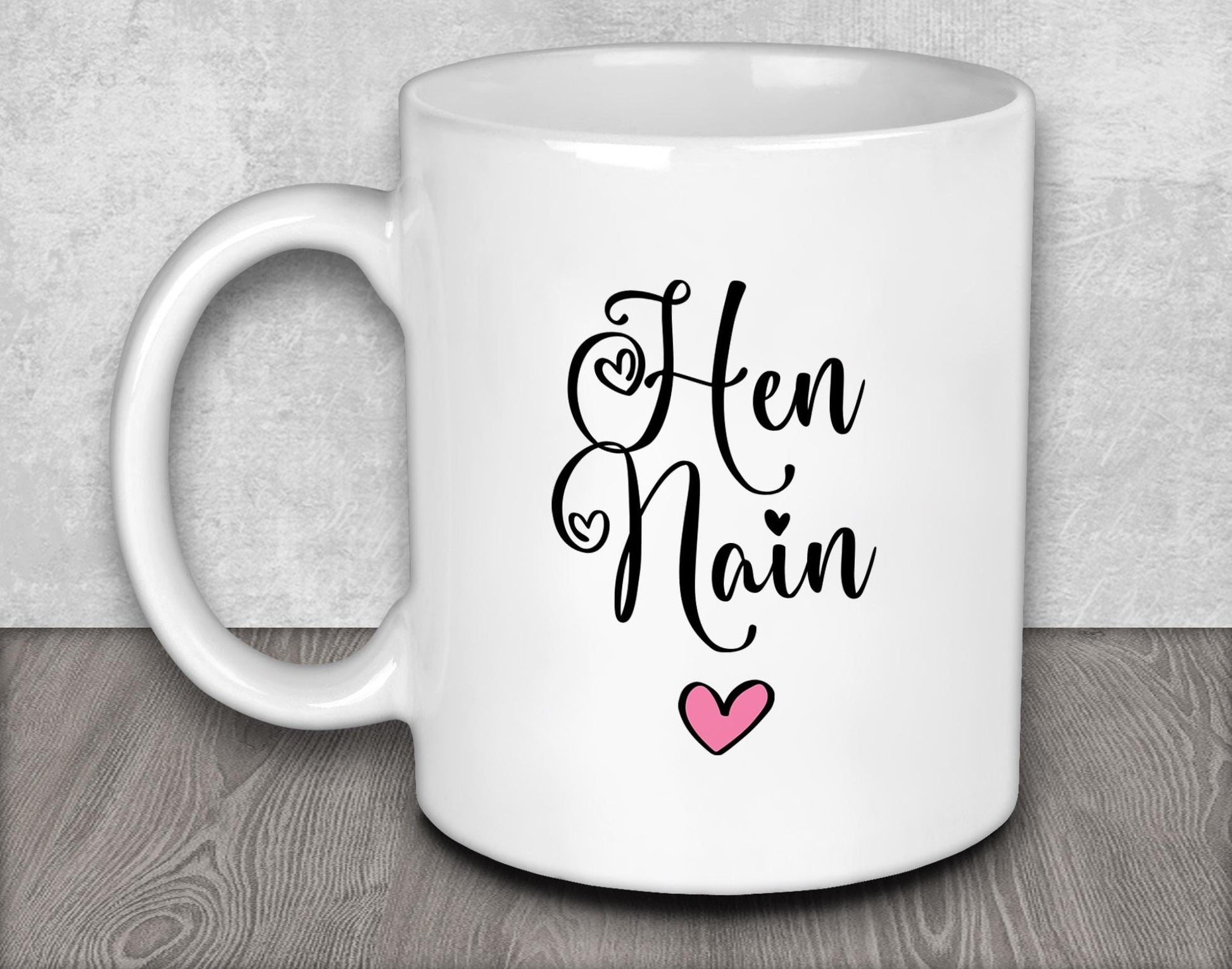 a white coffee mug with a pink heart on it