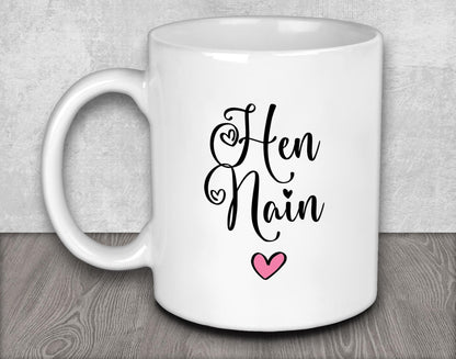 a white coffee mug with a pink heart on it