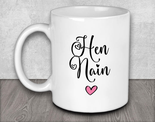 a white coffee mug with a pink heart on it