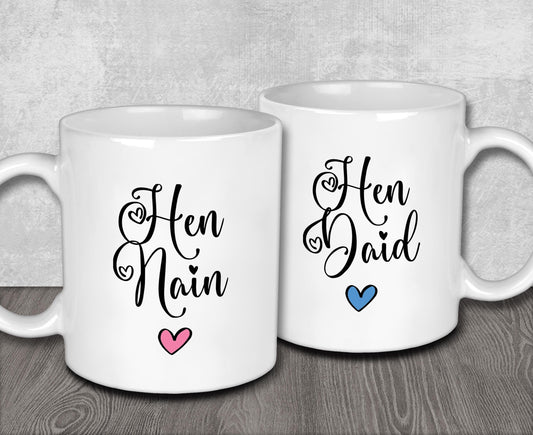 two coffee mugs with the words hen and dad printed on them