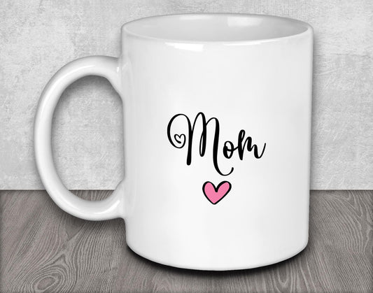 a white coffee mug with the word mom on it