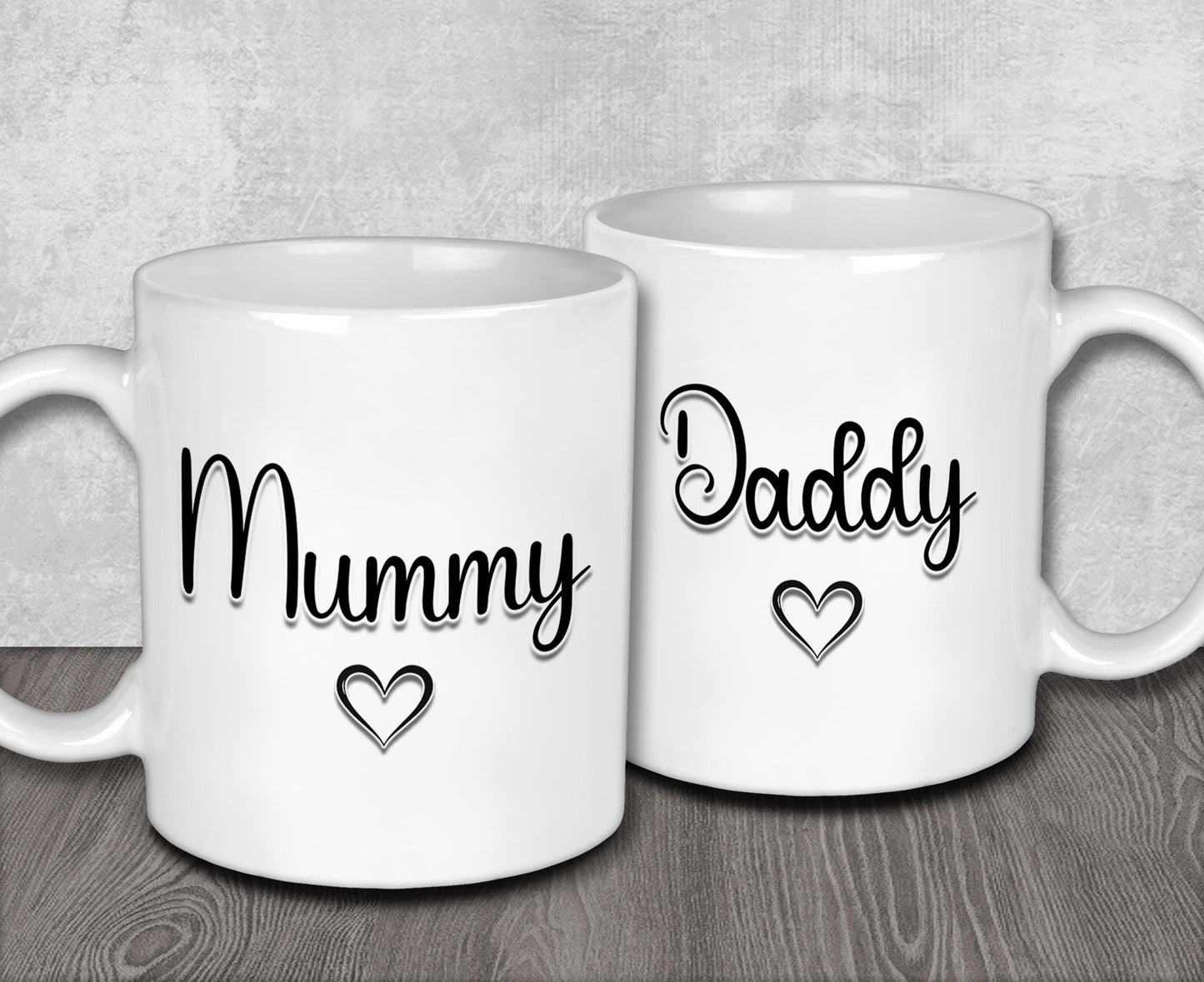 two white coffee mugs with the words mommy and daddy printed on them