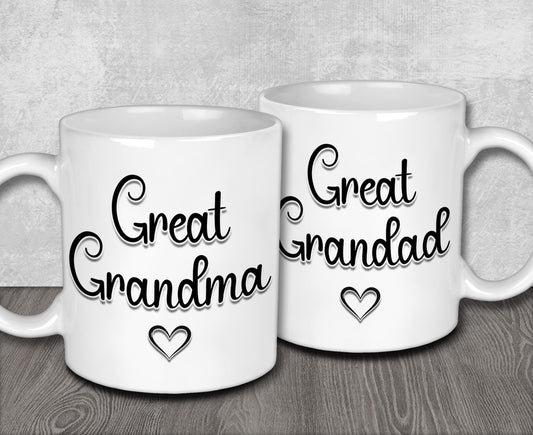 two white coffee mugs sitting on top of a wooden table