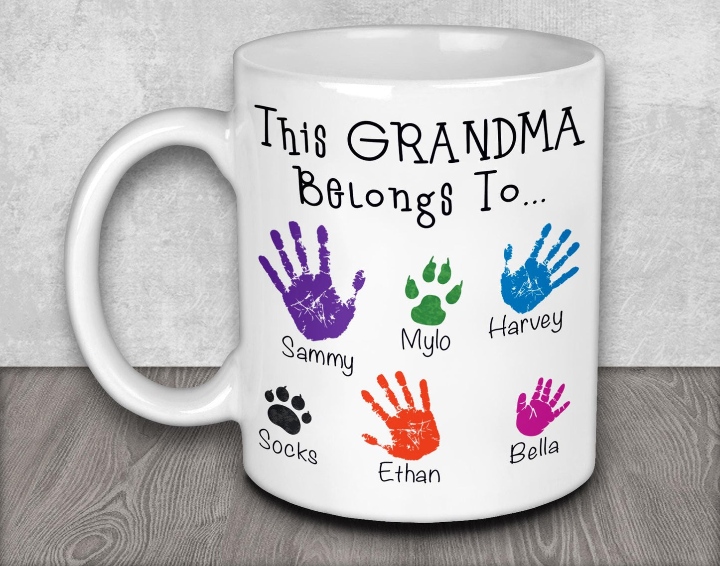 a white coffee mug with a handprinted picture of a dog&#39;s paw
