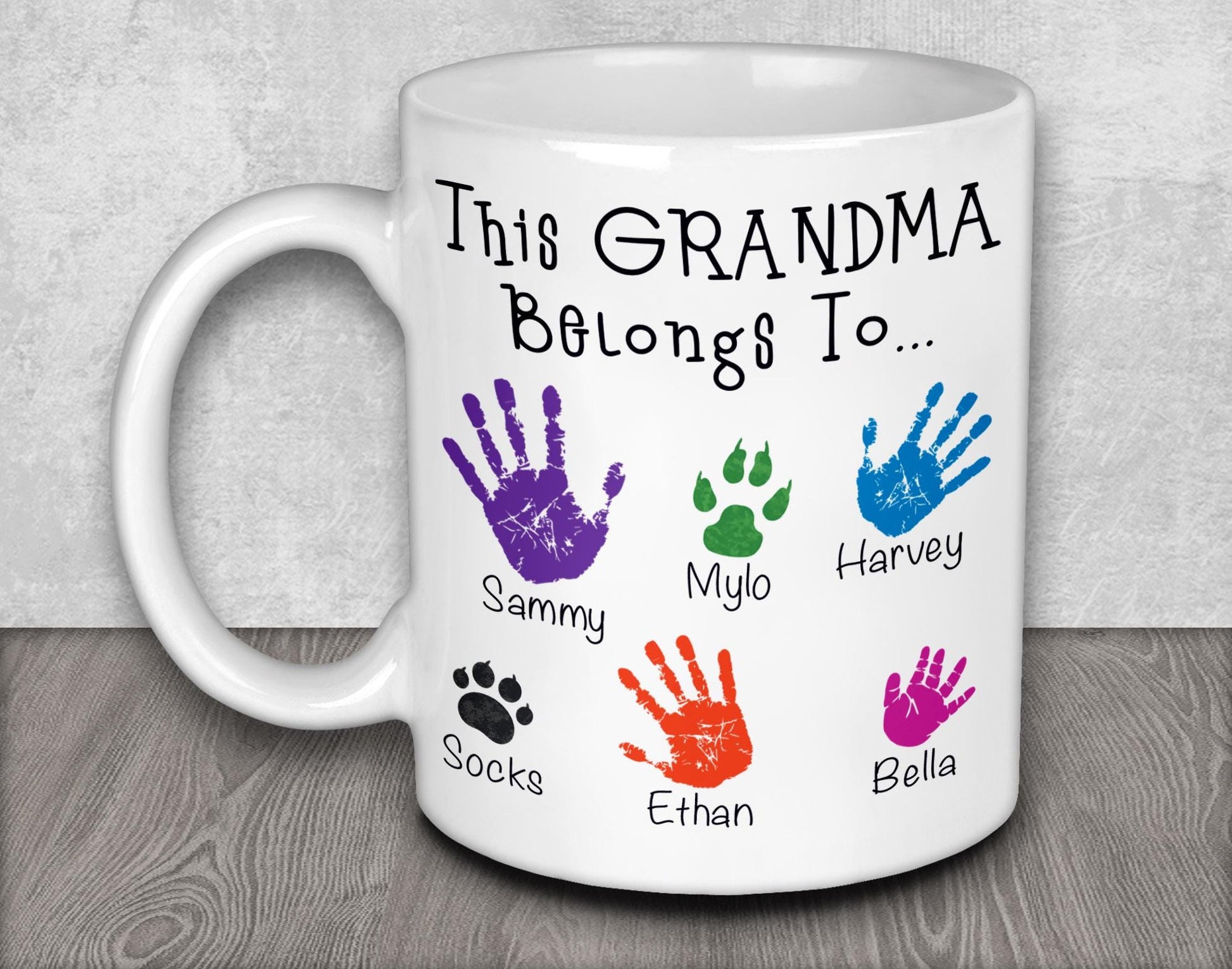 a white coffee mug with a handprinted picture of a dog&#39;s paw