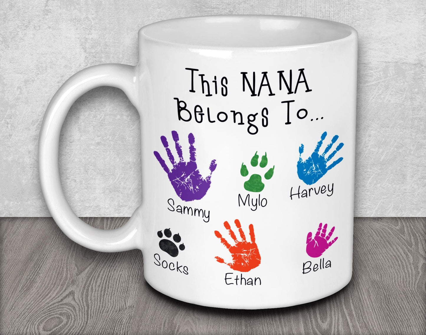 a white coffee mug with colorful hand prints on it