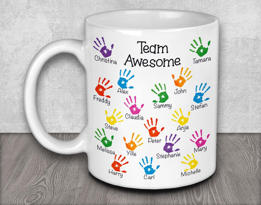 a white coffee mug with colorful hand prints on it