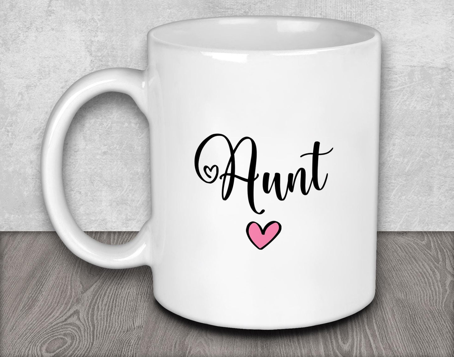 a white coffee mug with a pink heart on it