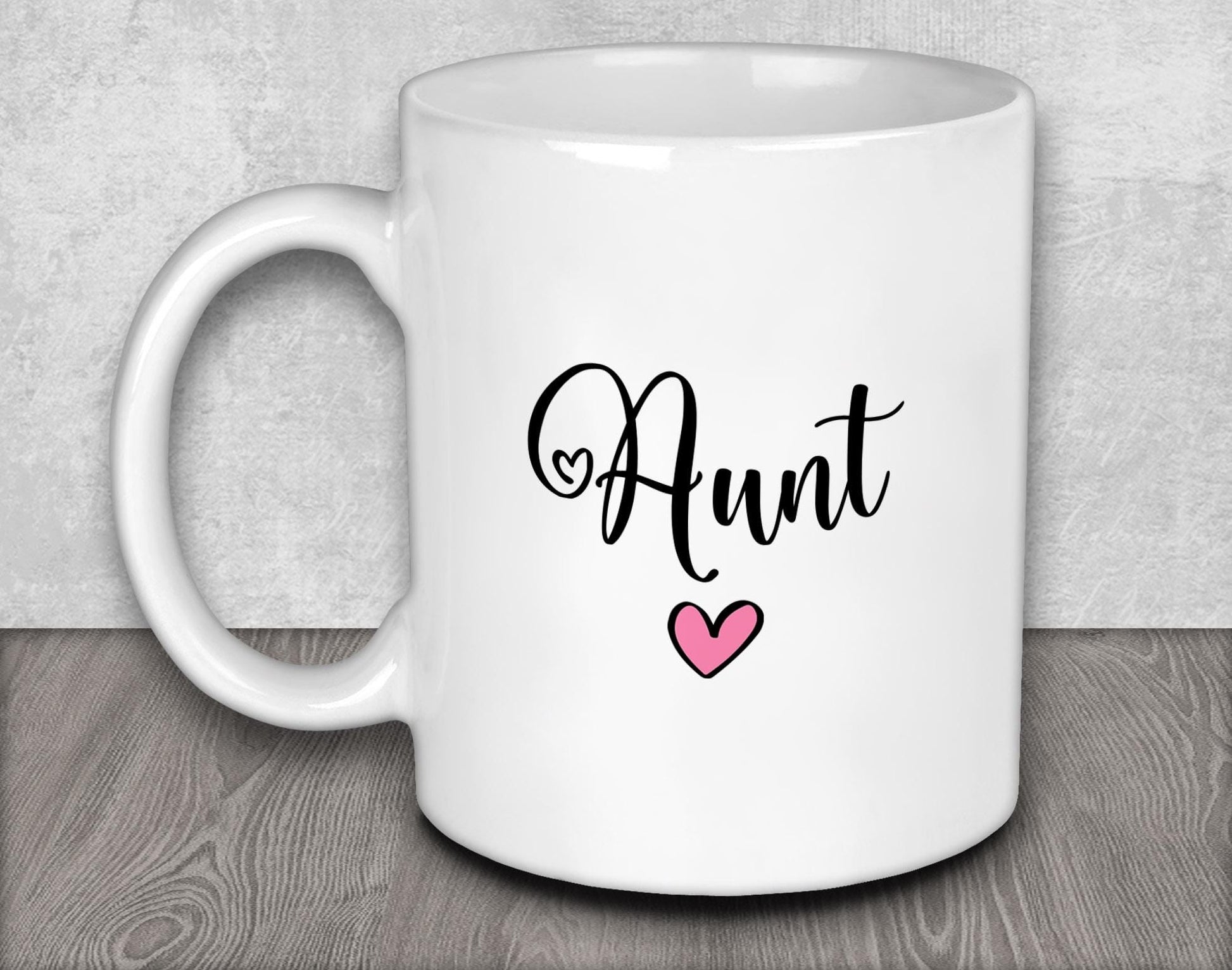a white coffee mug with a pink heart on it