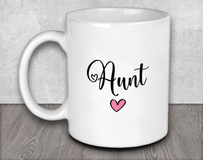 a white coffee mug with a pink heart on it