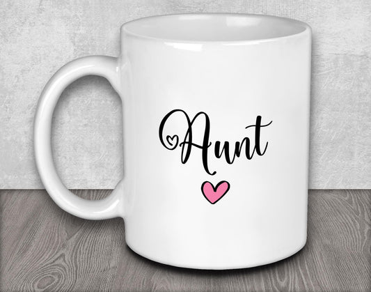 a white coffee mug with a pink heart on it
