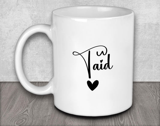 a white coffee mug with a black heart on it