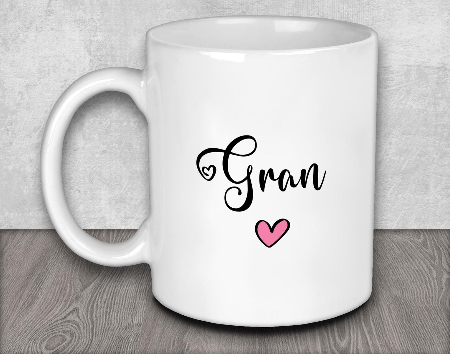 a white coffee mug with a pink heart on it
