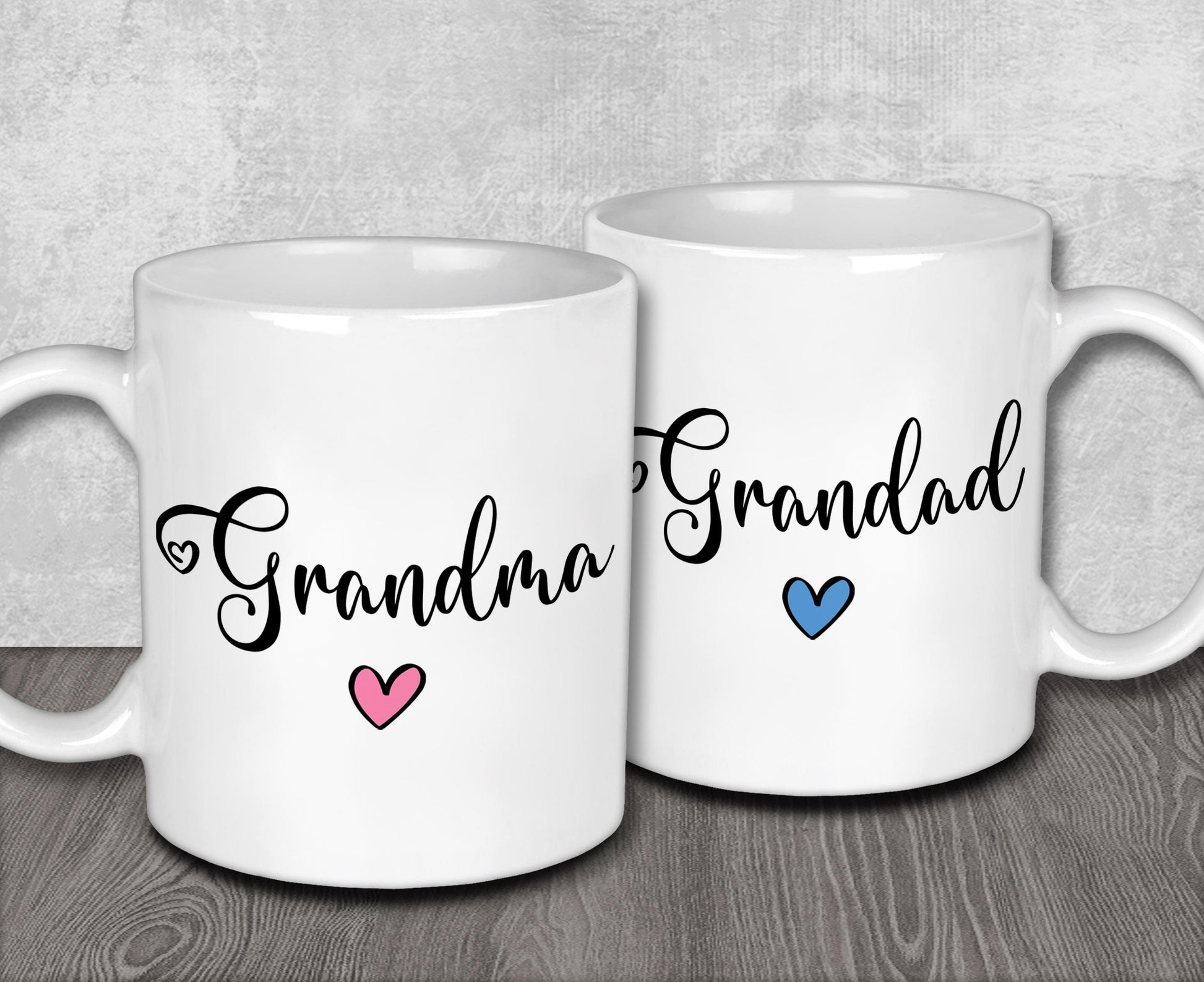 a couple of white coffee mugs sitting on top of a wooden table