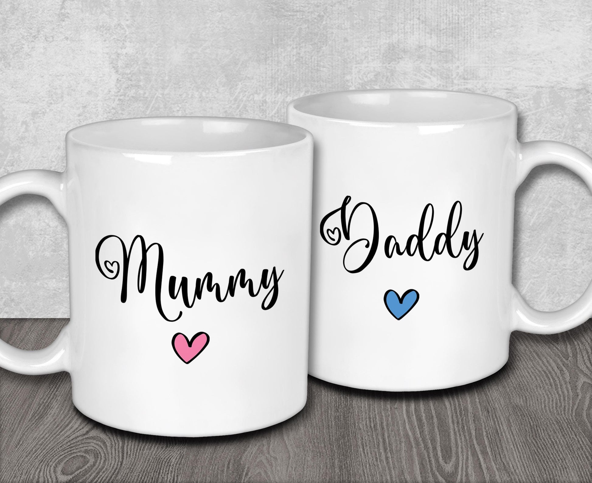 two coffee mugs with the words mommy and daddy printed on them