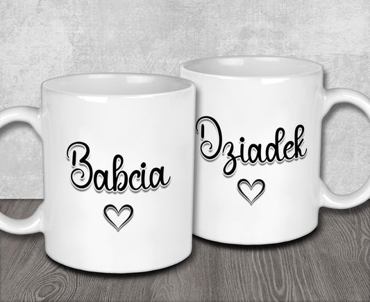 two white coffee mugs with hearts and the words babbia diadek