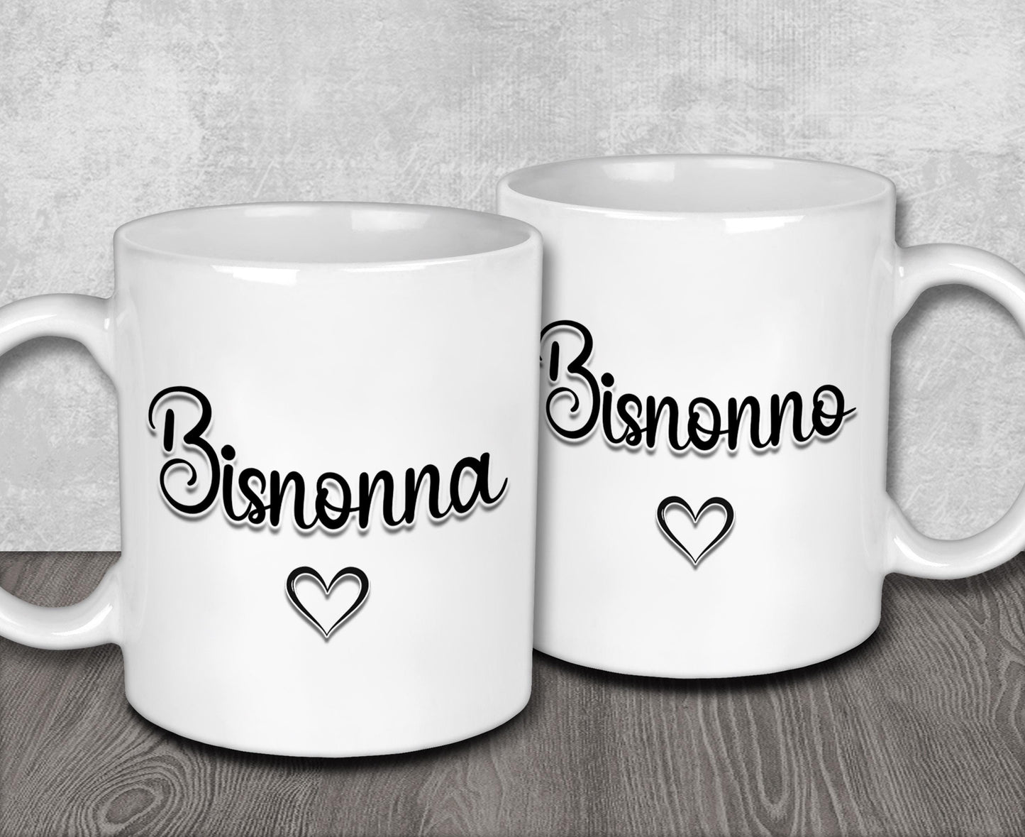 a couple of white coffee mugs sitting on top of a wooden table