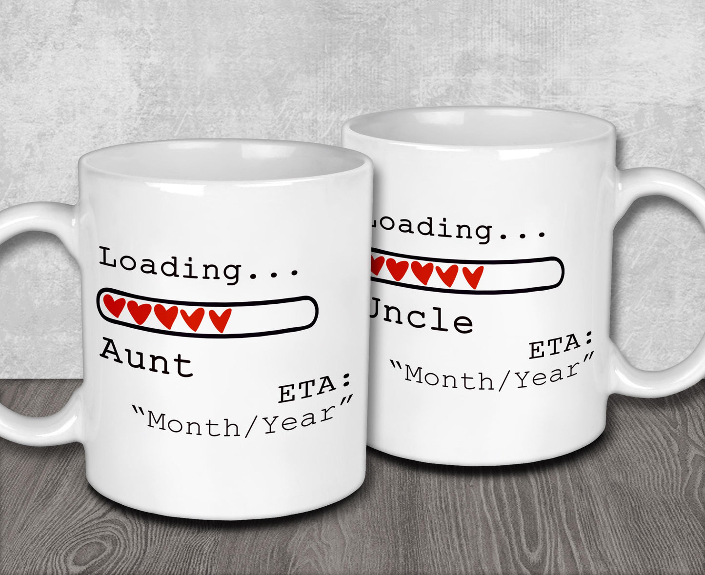 two white coffee mugs sitting on top of a wooden table