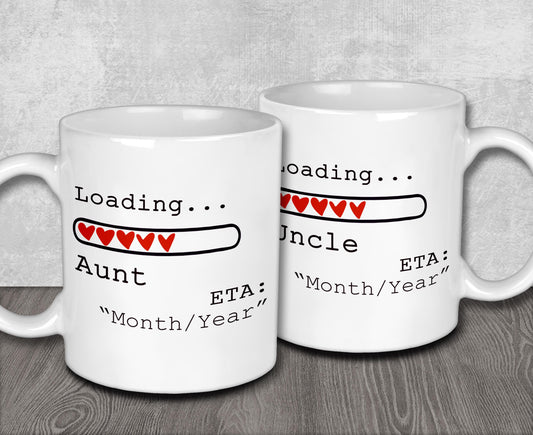 two white coffee mugs sitting on top of a wooden table