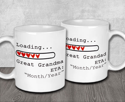 two white coffee mugs sitting on top of a wooden table