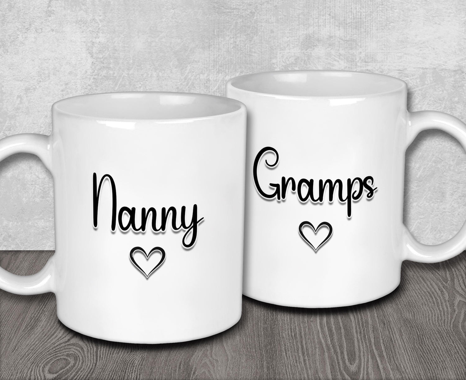 two white coffee mugs with black writing on them