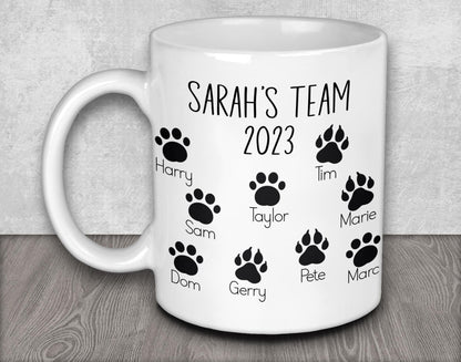 a white coffee mug with a dog&#39;s name and paw prints