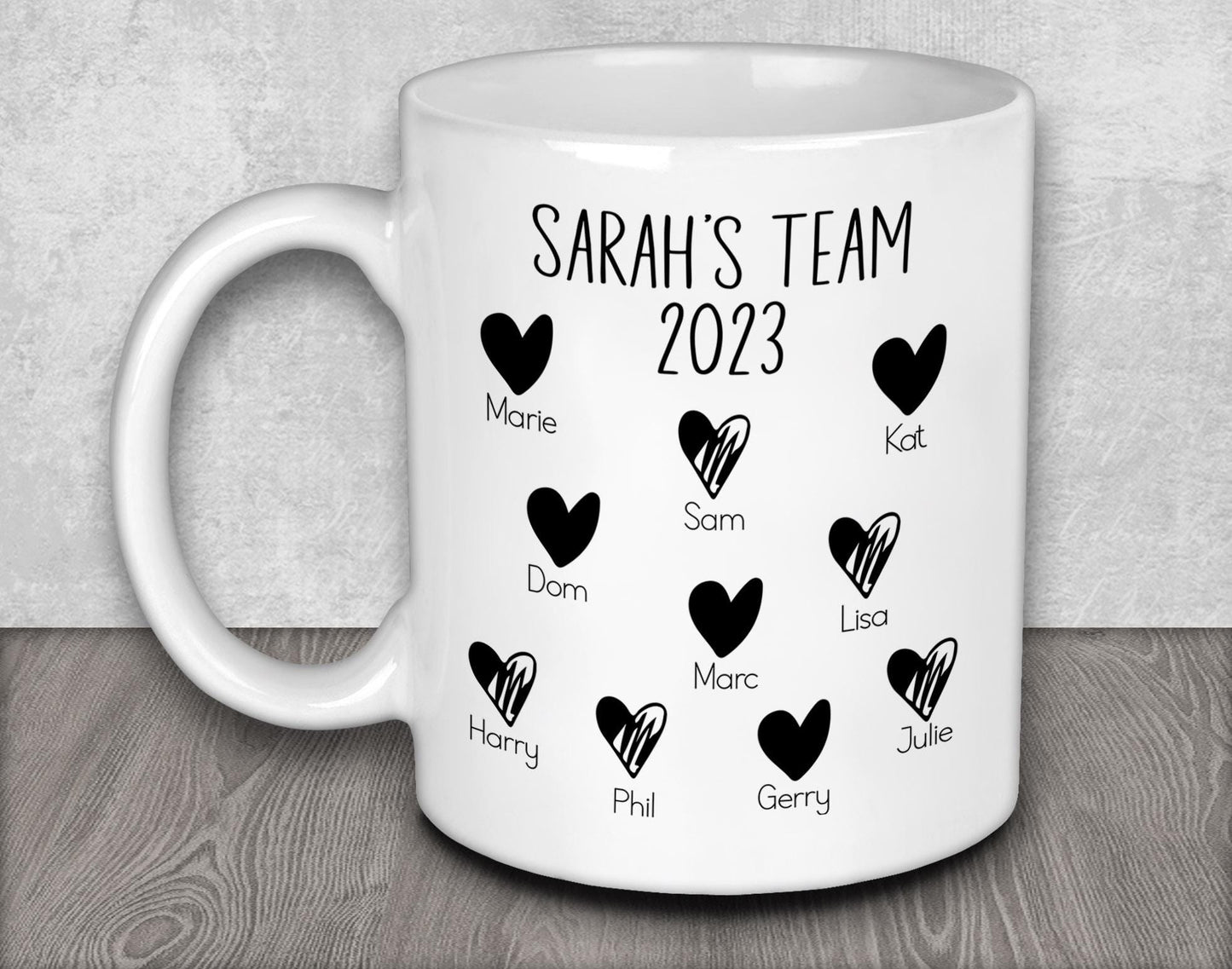 a white coffee mug with black hearts on it