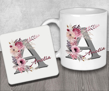 a white coffee mug with a floral monogrammed initial