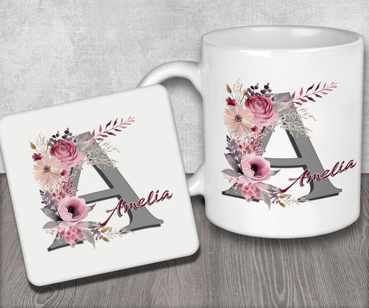 a white coffee mug with a floral monogrammed initial