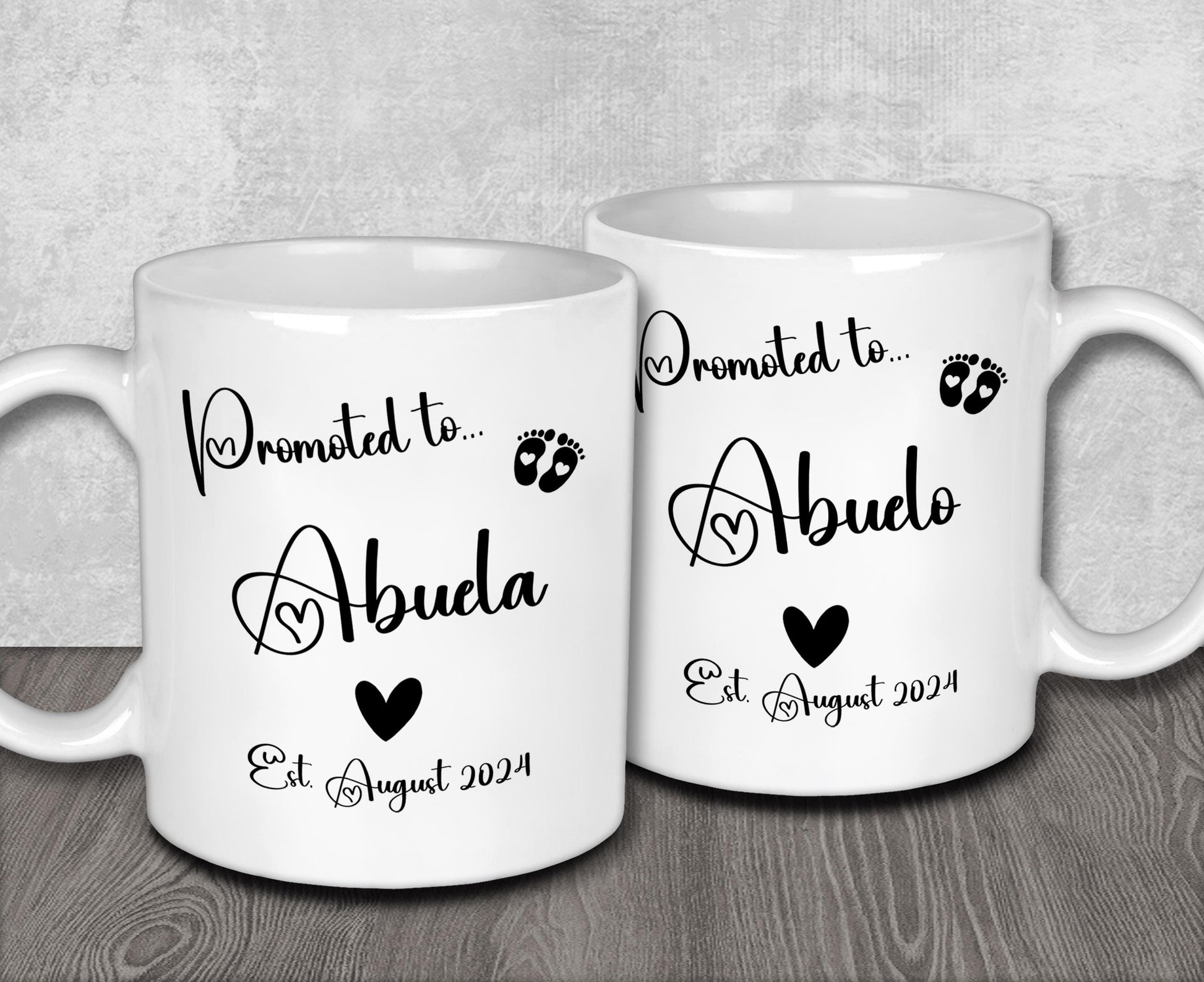 two white coffee mugs sitting on top of a wooden table