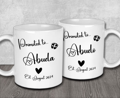 two white coffee mugs sitting on top of a wooden table