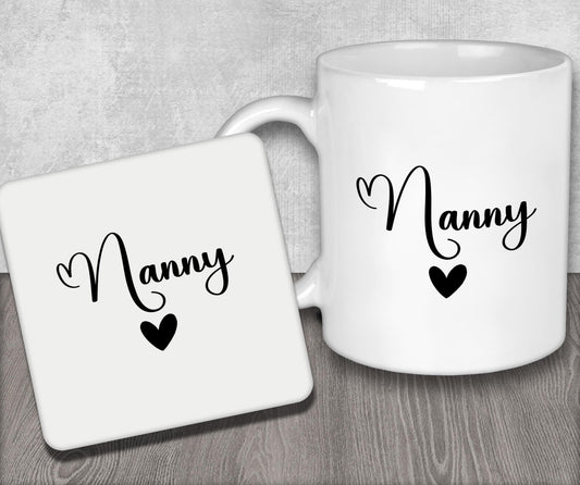 a couple of white coffee mugs sitting on top of a wooden table