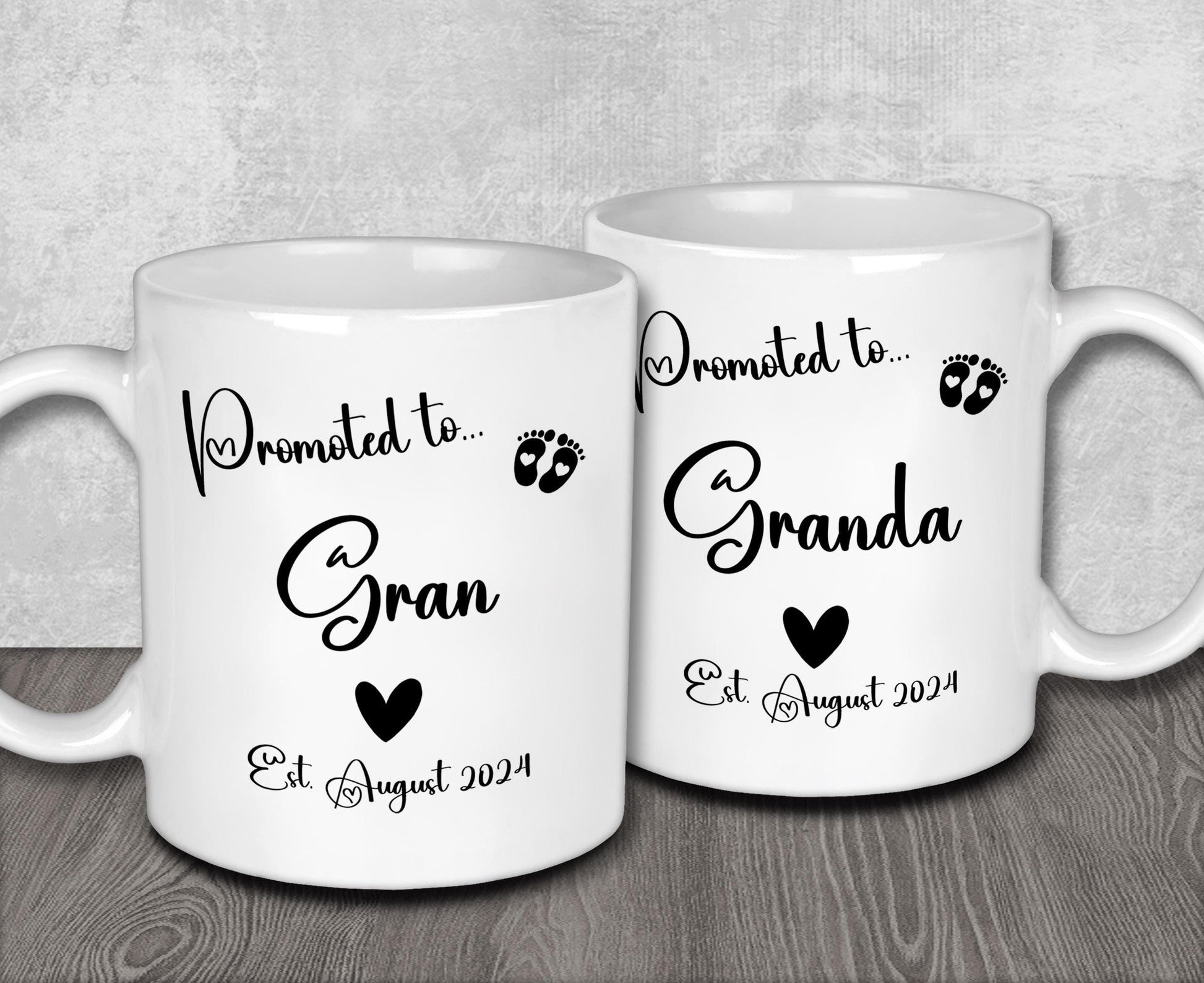 a couple of white coffee mugs sitting on top of a wooden table