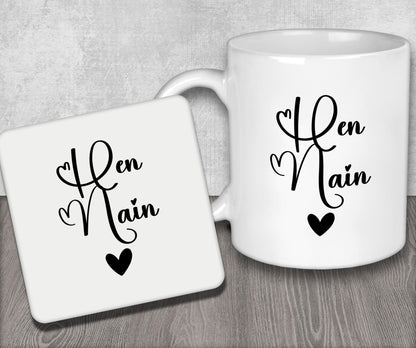 a couple of white coffee mugs sitting on top of a wooden table